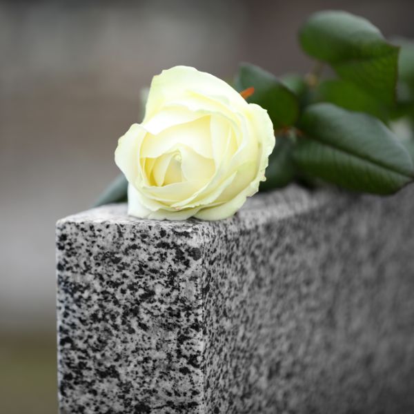 Granite headstone with rose on it
