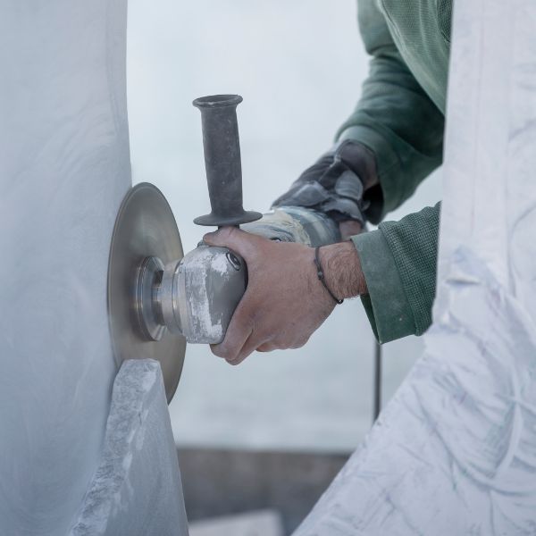 Person using a grinder on stone
