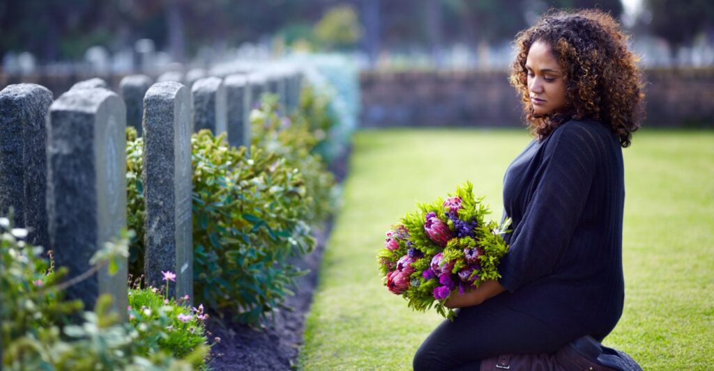 Woman by a headstone