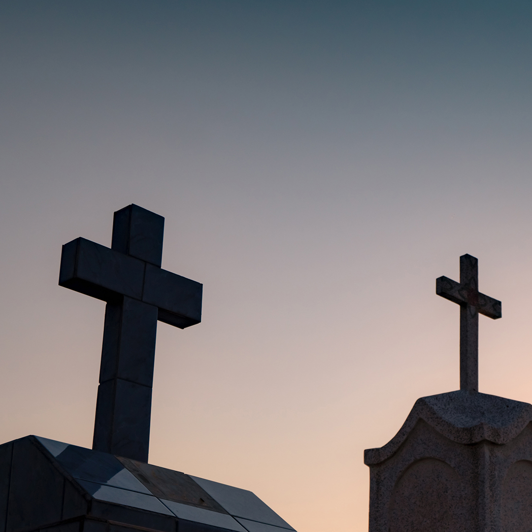 Cemetery or graveyard in the night with dark sky. Headstone and cross tombstone cemetery. Rest in peace concept. Funeral concept. Sadness, lament, and death background. Spooky and scary burial ground.